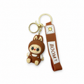 Brown bunny-ear character keychain with BOOM wrist strap and gold-tone clasp