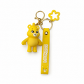 Yellow teddy bear character keychain with LOVE wrist strap, star charm and gold-tone hardware